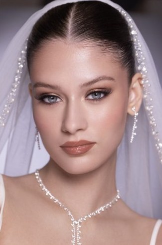 Bridal makeup in Dubai with veil and pearl necklace, by Beauty by Caro